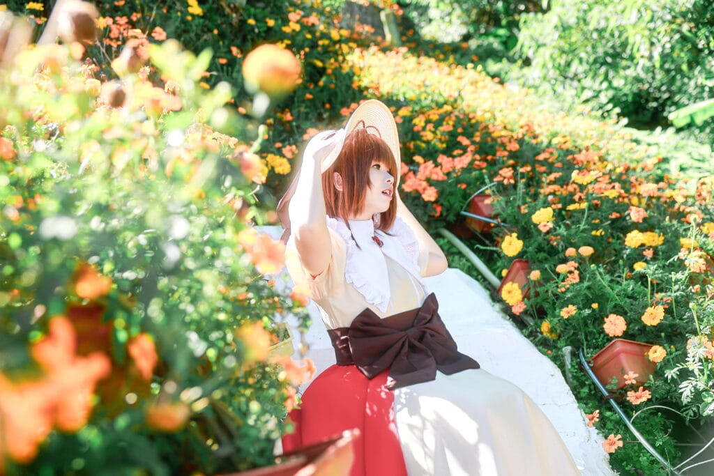 Cardcaptor Sakura cosplay portrait in a flower field with warm natural light