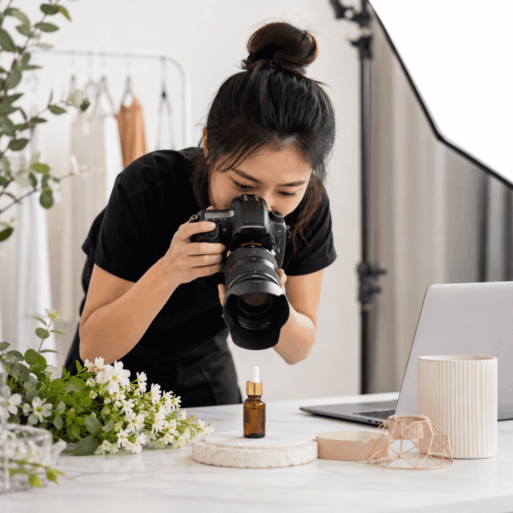 Female photographer capturing a product setup in a bright studio