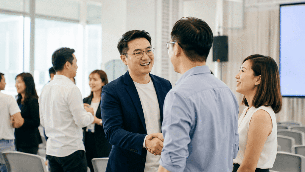 Brand Visibility Malaysia | Affiliate & Referral Content 13 Business professionals networking and building partnerships at a corporate event
